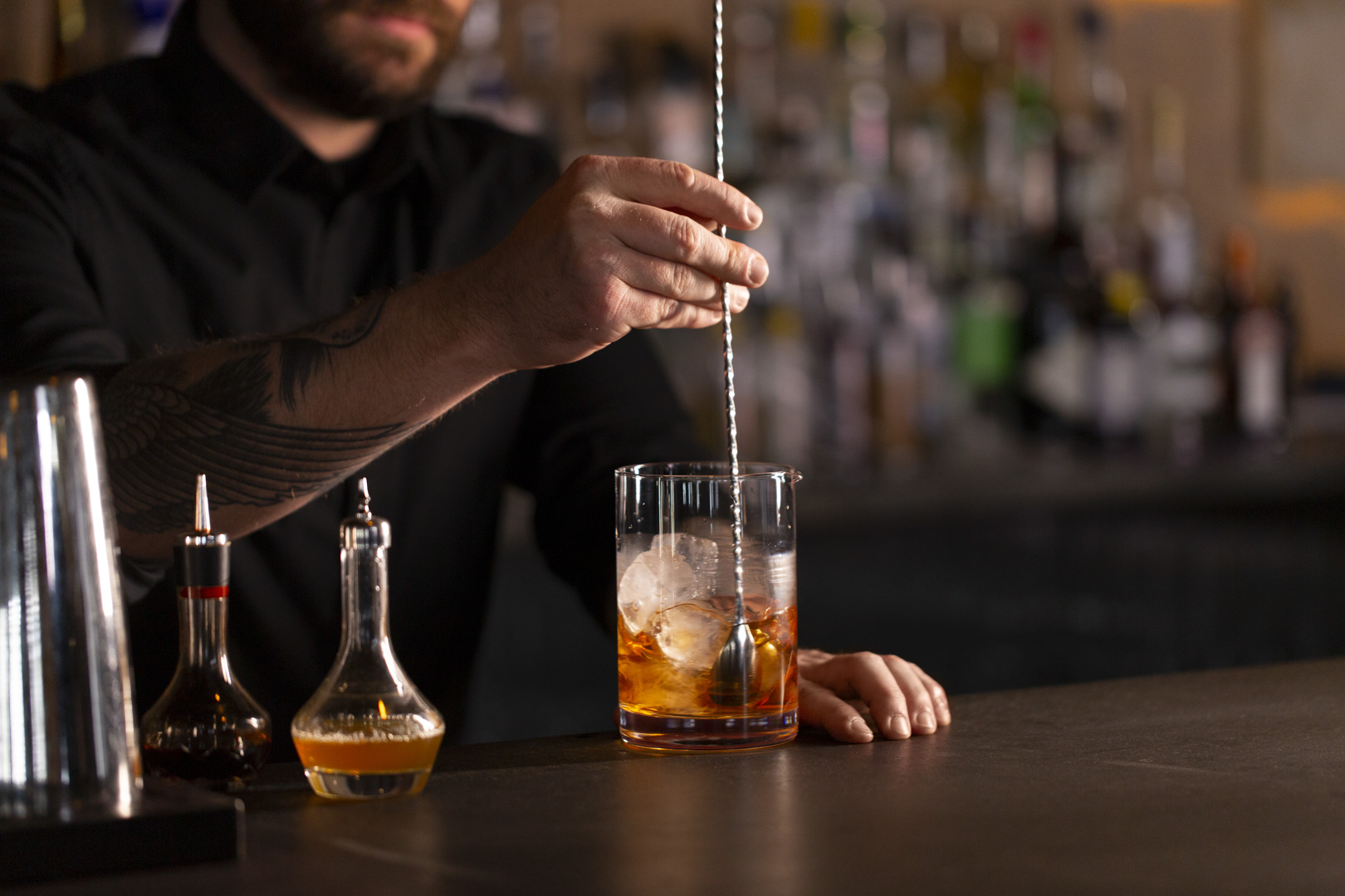 Bartender stirring cocktail