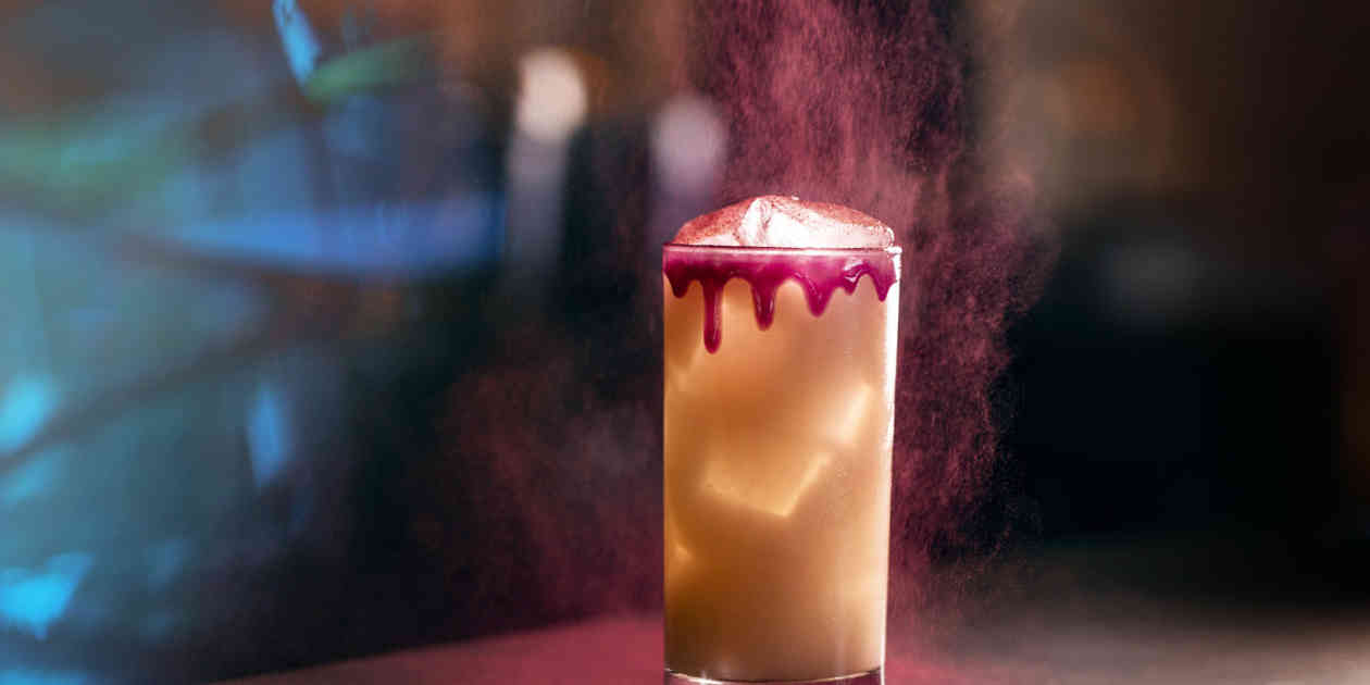 Specialty cocktail with pink drizzle